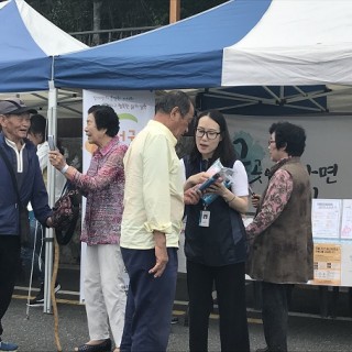 한마음축제에서 담당직원이 지역주민에게 행사에 대해 설명을 하고 있는 모습